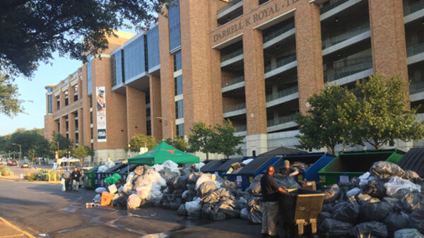 A photo of bags of trash and sorting bins outside Darrell K Royal - Texas Memorial Stadium.
