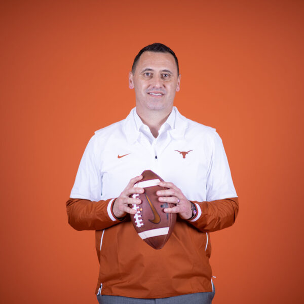 Portrait of Steve Sarkisian standing with a football in his hands