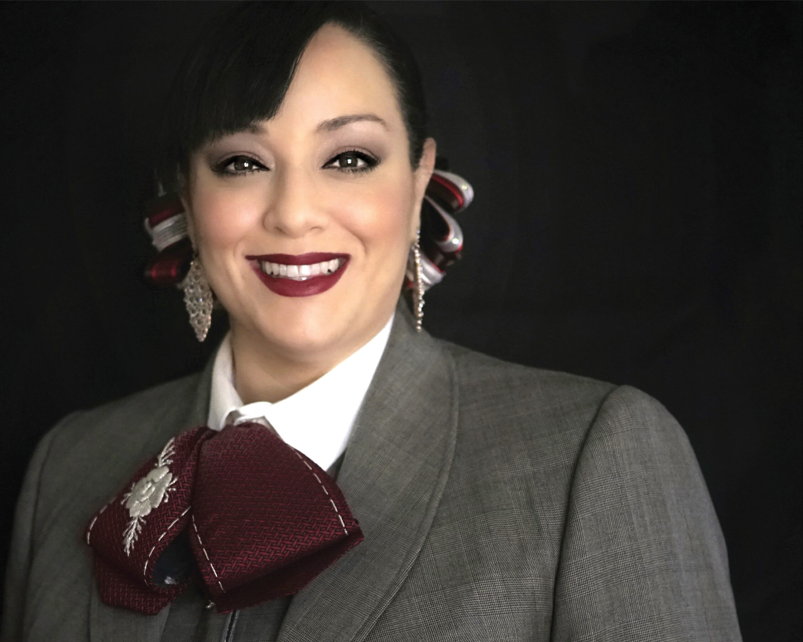 Portrait of woman in mariachi uniform smiling