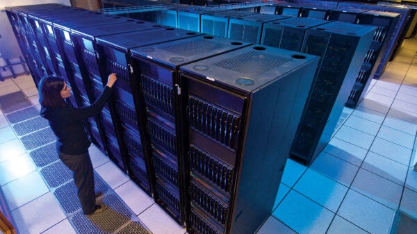 Woman looks at a supercomputer