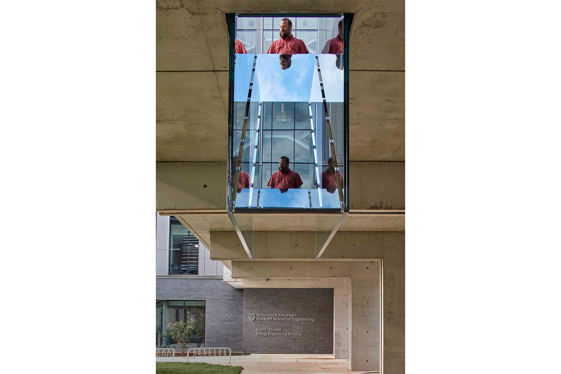 Bottom of sculpture reflecting person walking