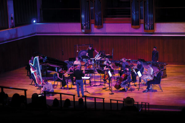 An orchestra performs on a stage