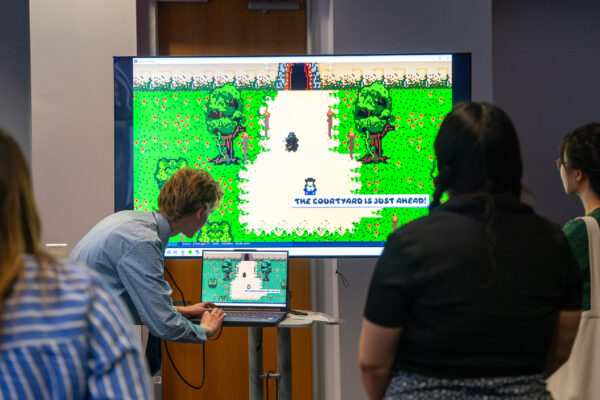 A video game is demonstrated to a group of people