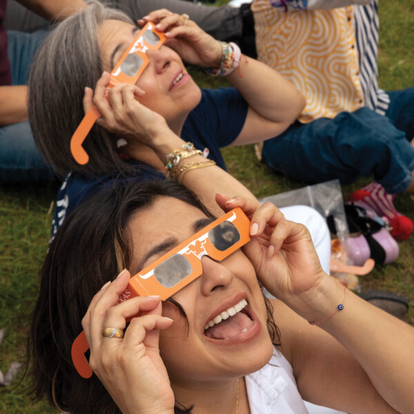 People view the 2024 Total Eclipse while wearing eclipse glasses