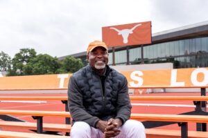 Man sitting on bleachers smiling