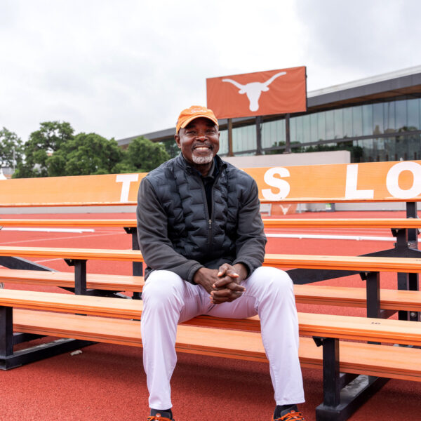 Man sitting on bleachers smiling