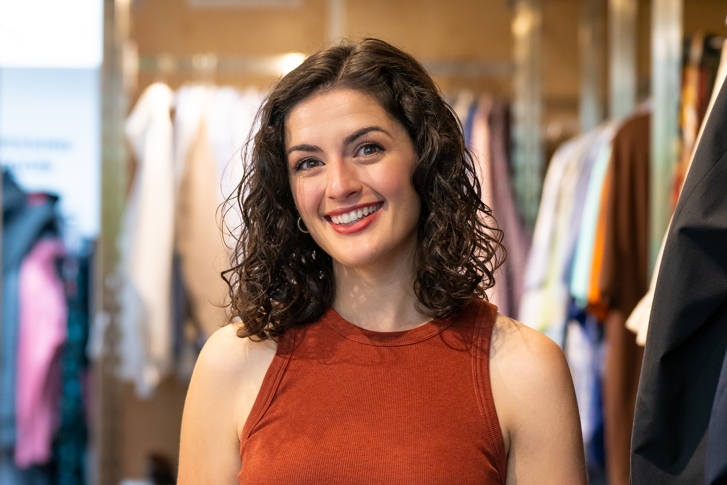 Young woman smiles in portrait at UT Outpost