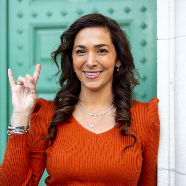 EmilyAnne Skinner holds up the Hook 'em, Horns hand signal